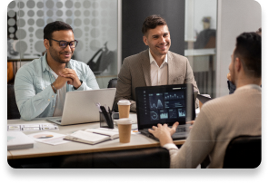 Business professionals collaborating during a meeting with laptops
