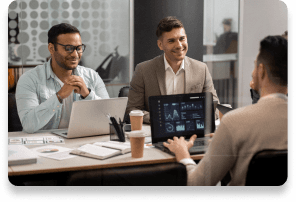 Business professionals collaborating during a meeting with laptops